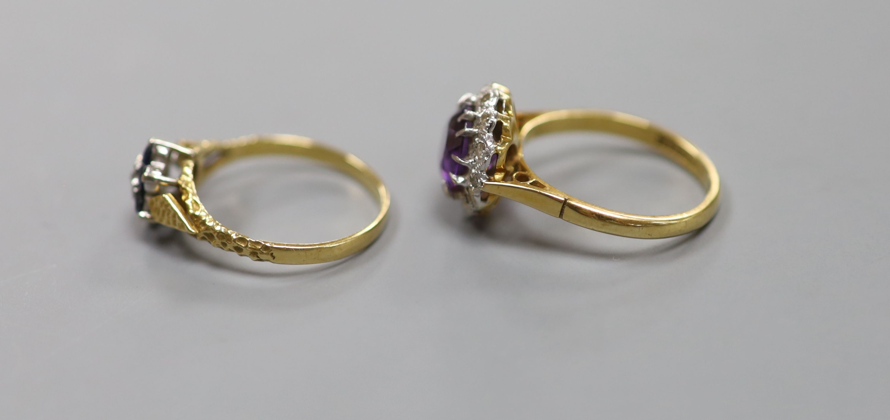 An 18ct yellow gold, diamond and amethyst cluster ring and an 18ct yellow gold, sapphire and diamond flower head ring, 7.1g